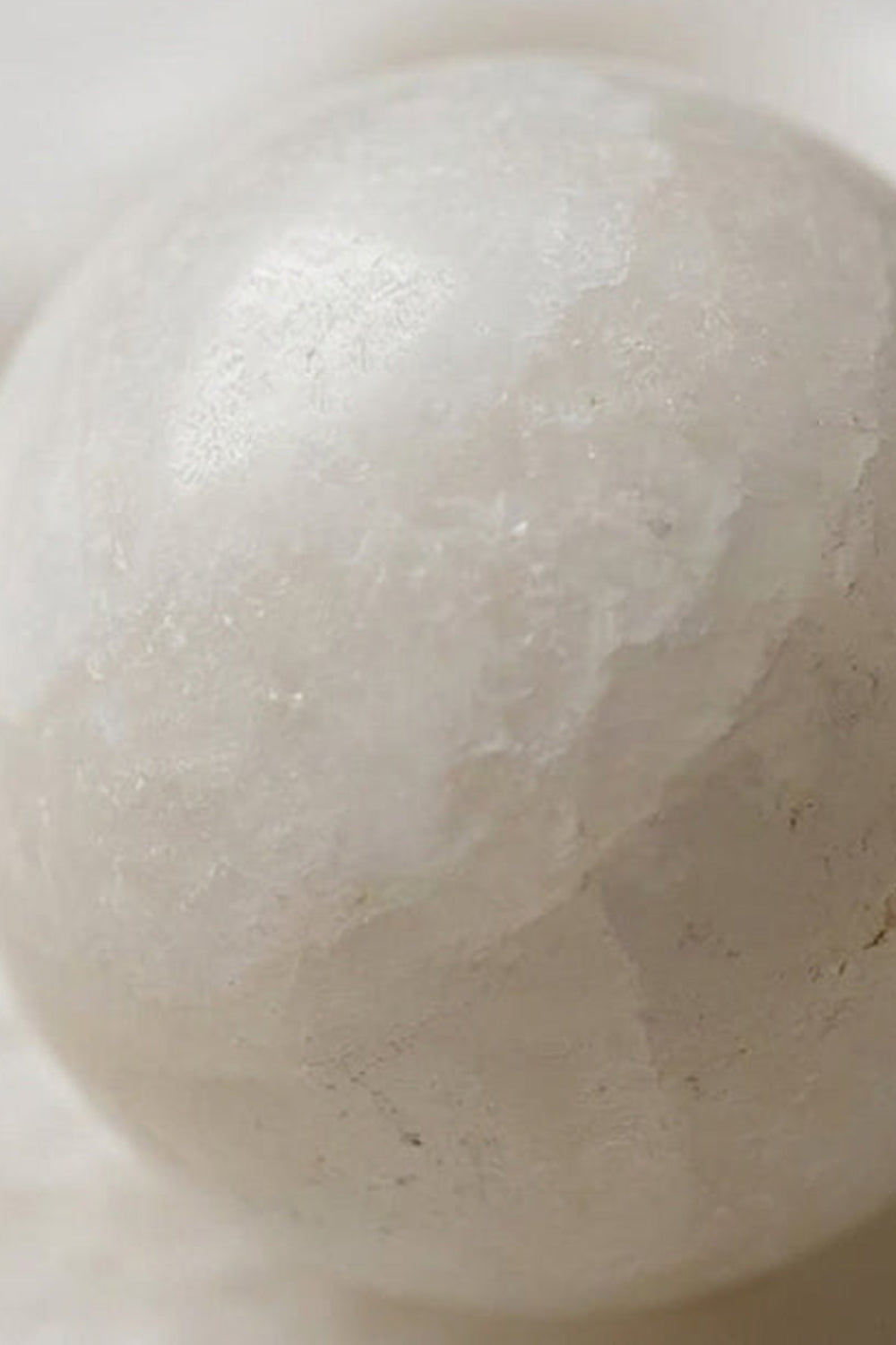 Elowen Petal Alabaster Wall Sconce | Natural Alabaster | Extreme macro close-up shot focusing on the smooth texture and veins of the central stone globe bulb | Samu Lamp