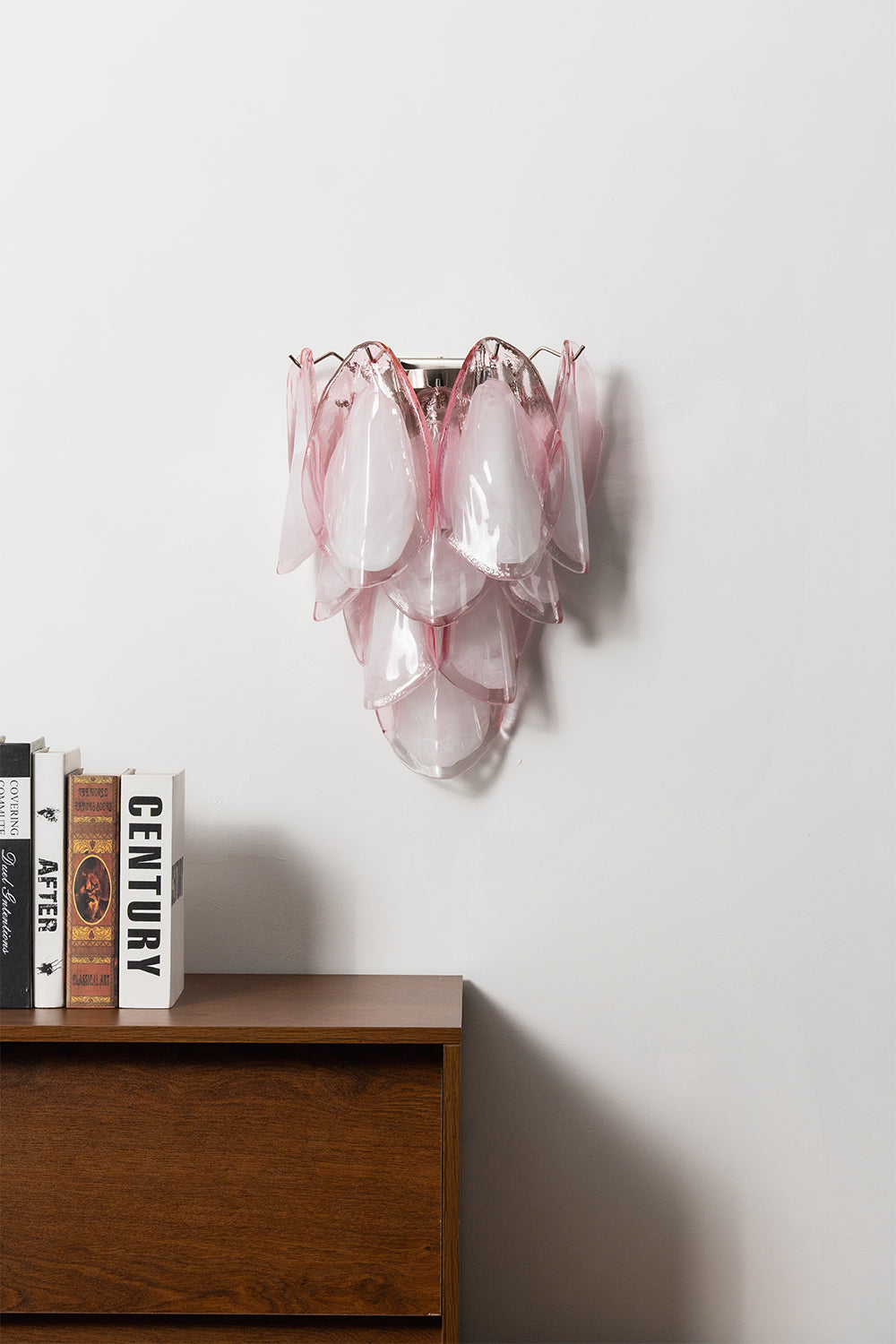 Elysian Bloom Glass Wall Lamp | Metal, Glass | Frontal view of the unlit pink glass wall lamp mounted above a wooden cabinet | Isolated shot | Samu Lamp