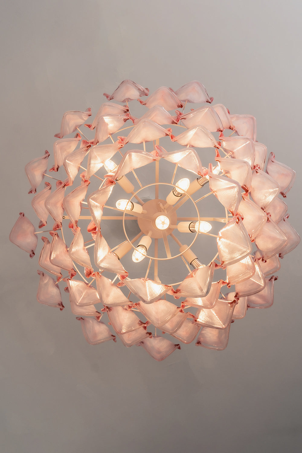 Elysian Bloom Rose Glass Chandelier | Metal, Glass | Directly looking up into the illuminated chandelier, showcasing the radial petal arrangement | Detail shot | Samu Lamp