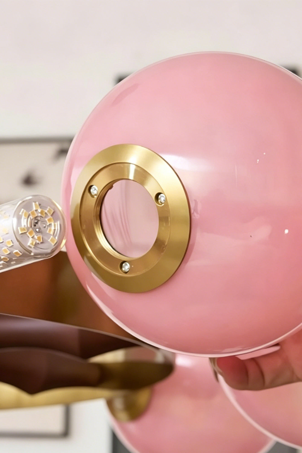 Detail of the pink glass globe and brass fitting | Glass, Metal | Showing the glossy pink finish and mounting ring | Samu Lamp