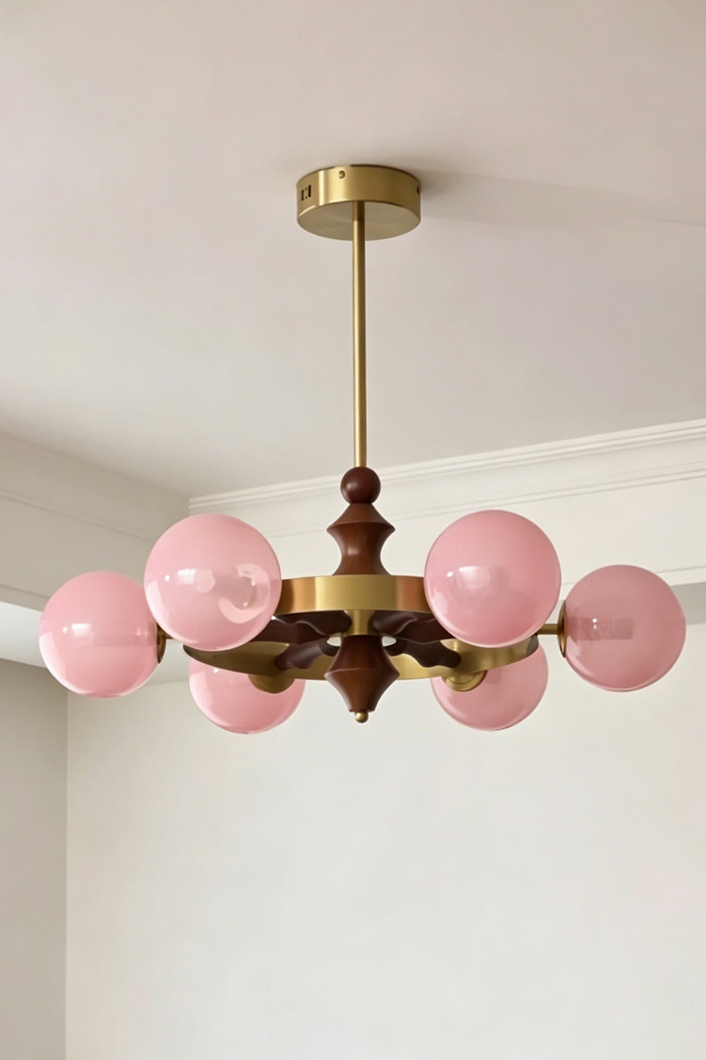 Lit pink glass globe version of the Elysian Circlet Chandelier | Metal, Glass, Wood | Perspective view showing the circlet design | Samu Lamp