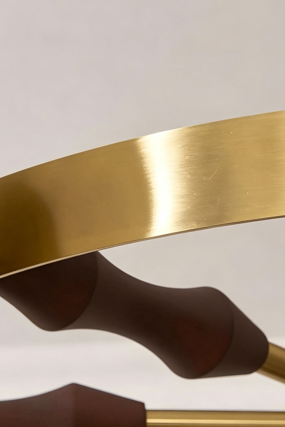 Detailed view of the brass ring and wooden support | Metal, Wood | Showing the warm metallic finish and wood grain | Samu Lamp