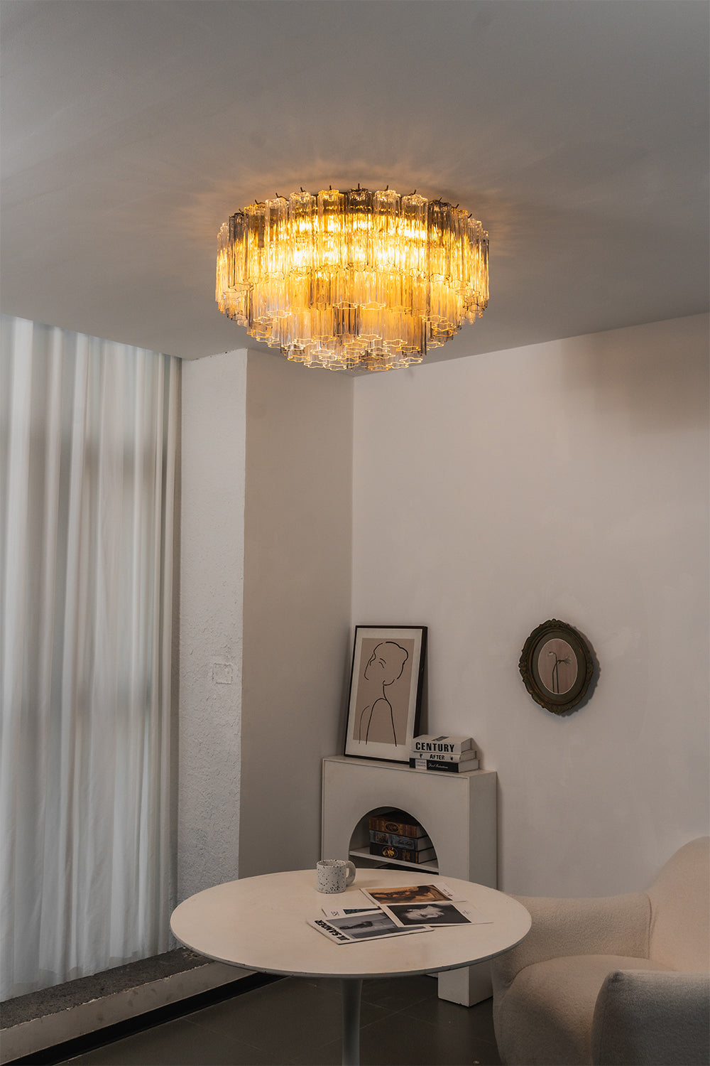 Elysian Tiered Fluted Ceiling Light | Glass, Metal | Installed in a minimalist interior transition space, throwing soft light over a round white lounge table | Samu Lamp