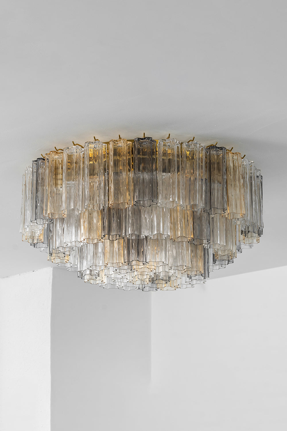 Elysian Tiered Fluted Ceiling Light | Glass, Metal | Unlit corner view of the tiered glass flush mount showcasing the clear texture of overlapping rods and a gold canopy base | Samu Lamp