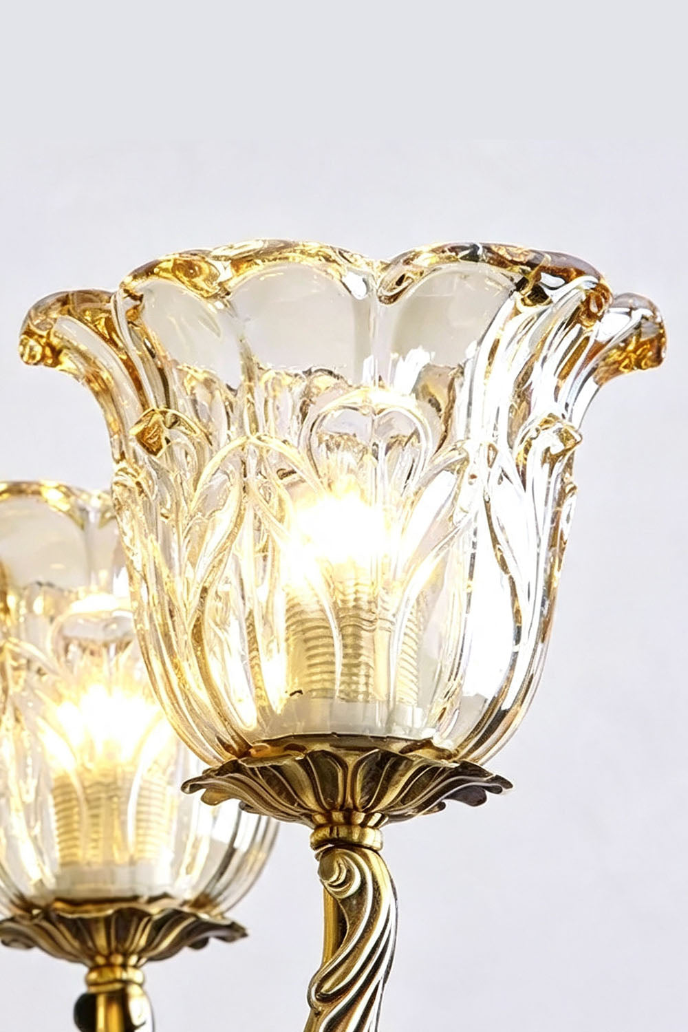 Emeric Green Porcelain and Brass Chandelier featuring elegant glass shades with intricate detailing.