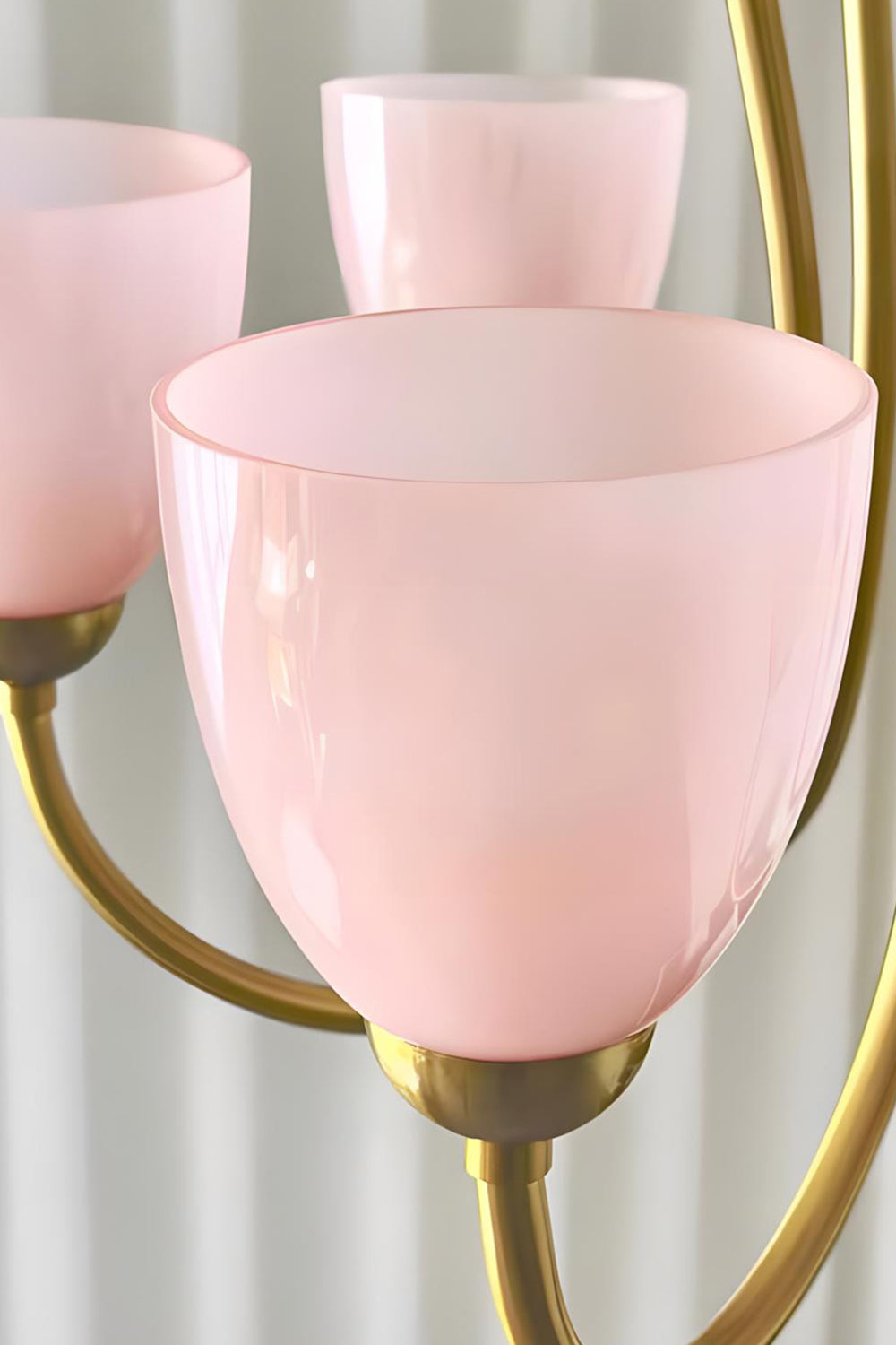 Close-up of illuminated pink glass shades on a Ethereal Floret Chandelier | Metal, Glass | Detail shot of lit shades on metal arms | Samu Lamp