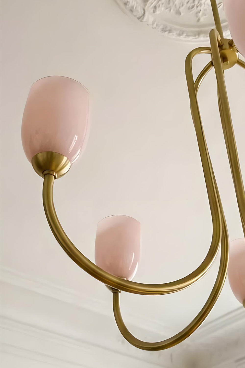 Close-up detail of the intricate brass-finished metal frame of a Ethereal Floret Chandelier | Metal | Functional detail view of the ceiling mount and arms | Samu Lamp