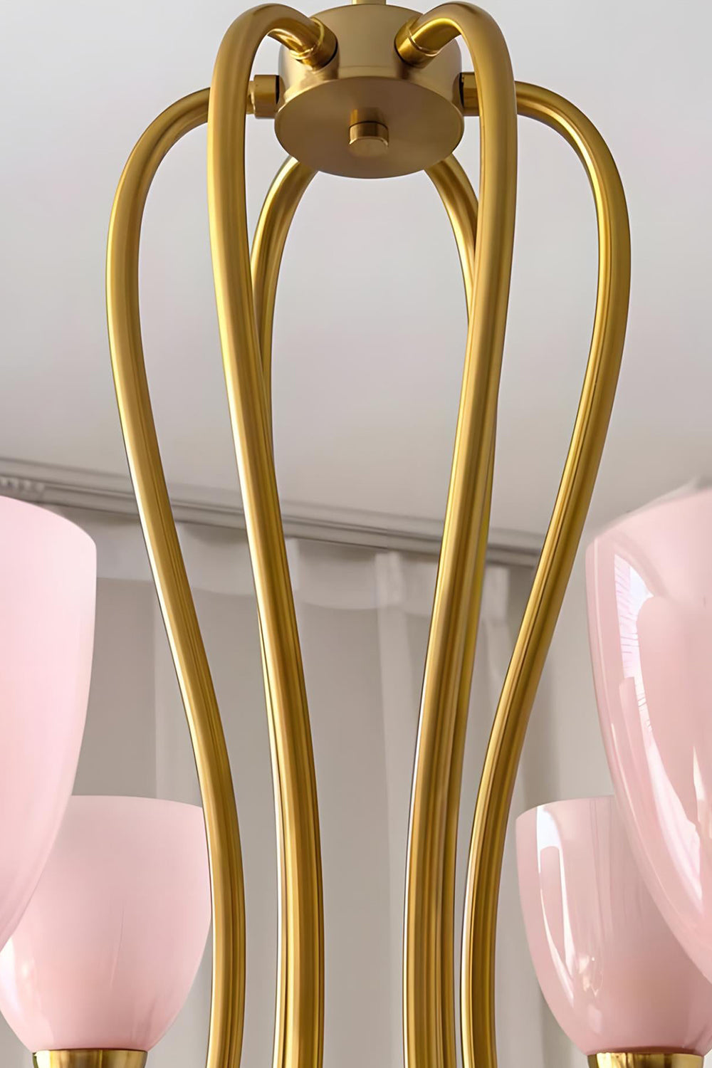 Close-up detail of the intricate brass-finished metal frame of a Ethereal Floret Chandelier | Metal | Functional detail view of the ceiling mount and arms | Samu Lamp