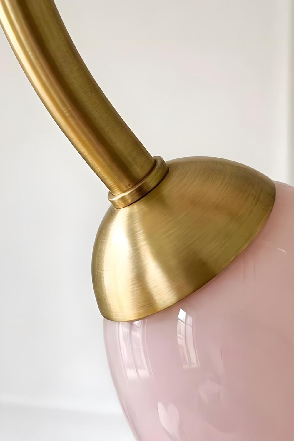 Detail of the brass-finished metal arm joining a pink glass shade base | Metal, Glass | Functional connection point of Ethereal Floret Chandelier | Samu Lamp