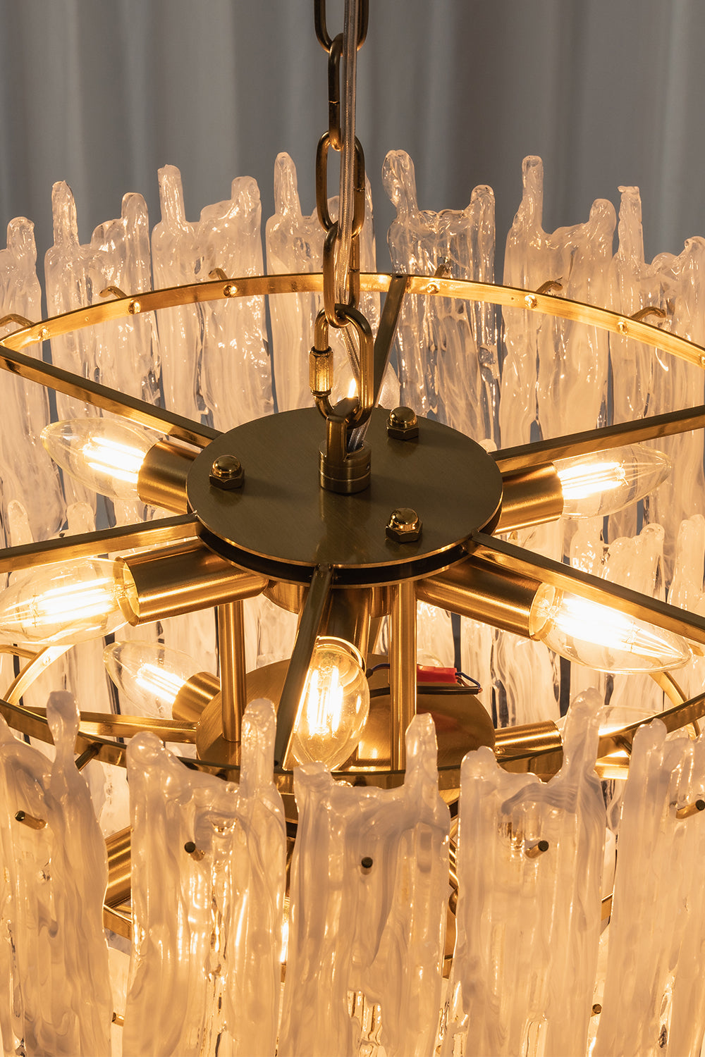 Ethereal Icicle Waterfall Chandelier | Glass, Metal | Internal top-down view showing the radial gold metal frame and lit bulb configuration | Detail shot | Samu Lamp