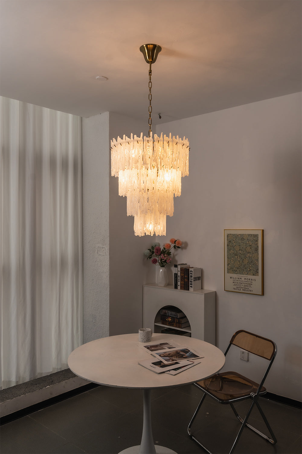 Ethereal Icicle Waterfall Chandelier | Glass, Metal | Mounted over a simple round table in a minimalist dining corner next to white curtains | Samu Lamp