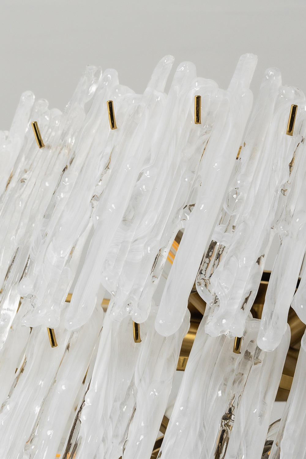 Ethereal Icicle Waterfall Chandelier | Glass, Metal | Close-up focus on the textured, melting-ice appearance of the white frosted glass panels | Detail shot | Samu Lamp