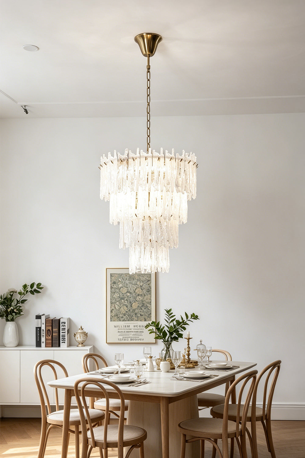 Ethereal Icicle Waterfall Chandelier | Glass, Metal | Illuminating a contemporary dining room setup above a wooden dining table and matching chairs | Samu Lamp