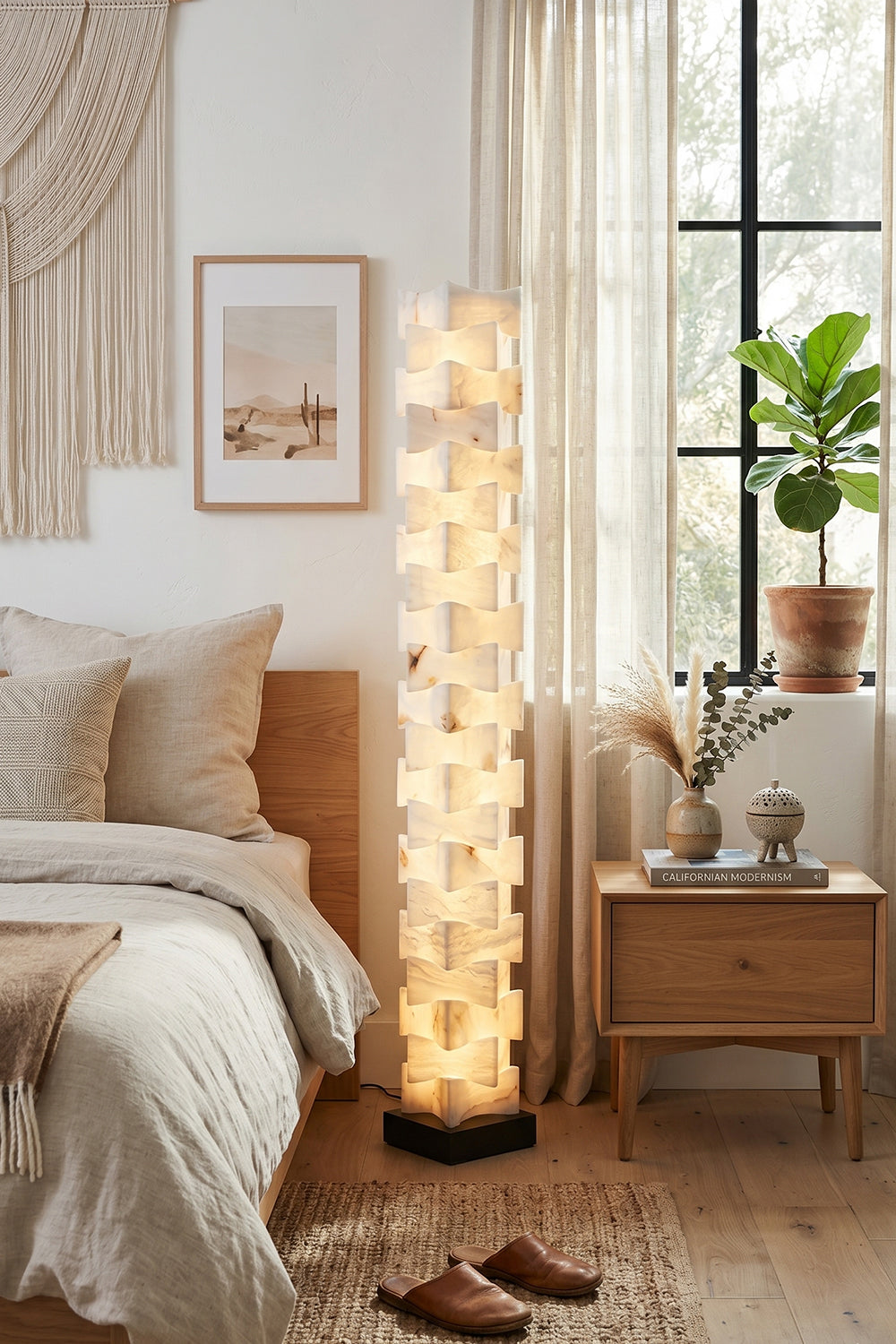 Ethereal Monolith Alabaster Floor Lamp | Lit in bohemian bedroom interior | Placed near windows with plants and rattan textures | Samu Lamp