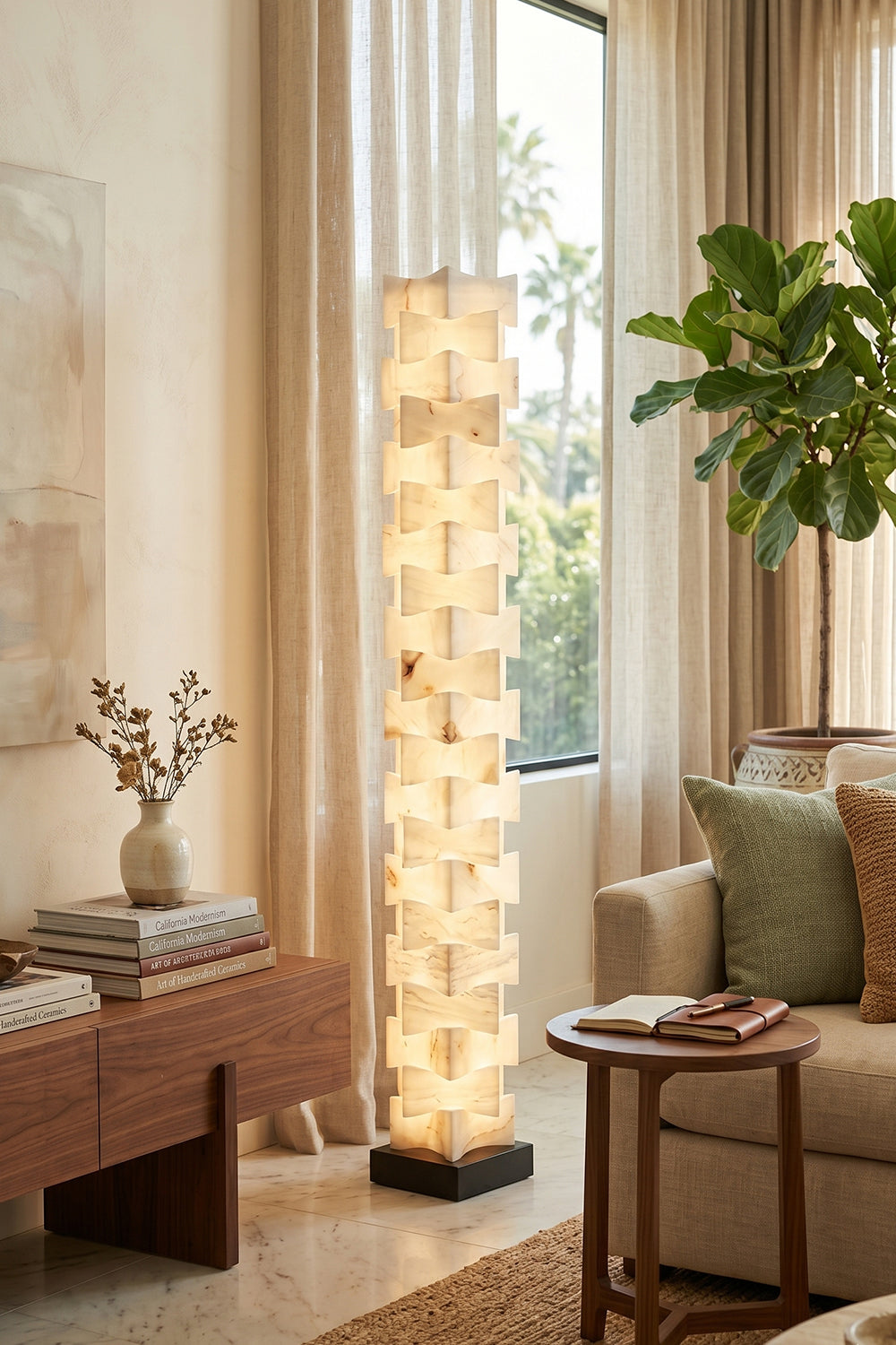 Ethereal Monolith Alabaster Floor Lamp | Lit next to wooden side table | Curated pottery, books, and Fiddle Leaf Fig plant | Clean modern living room | Samu Lamp