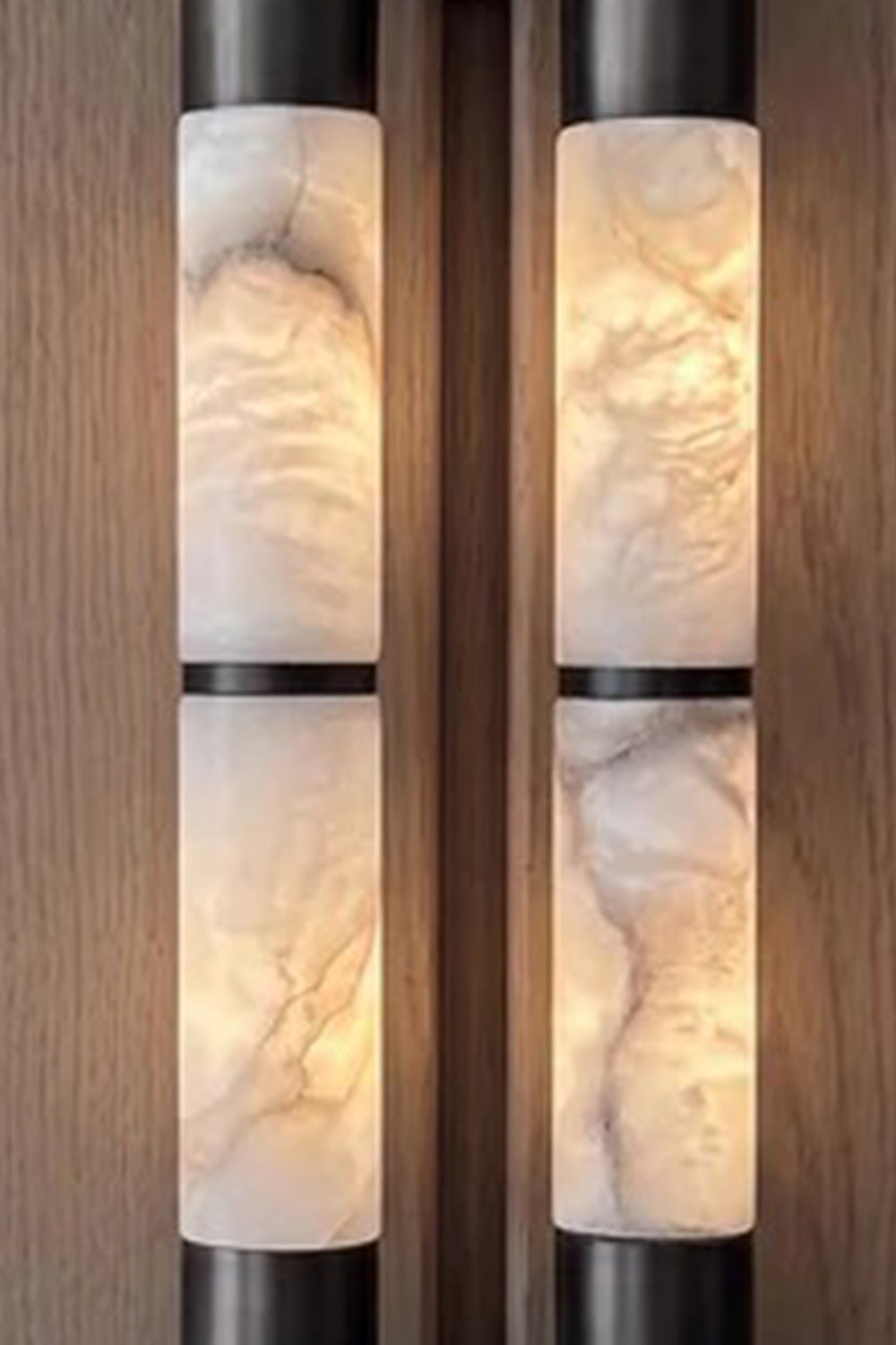 Evadne Alabaster Link Wall Sconce | Alabaster, Metal | Detailed close-up shot highlighting the intense cloudy translucent textures and unique mineral veining of the twin illuminated alabaster rods | Detail shot | Samu Lamp