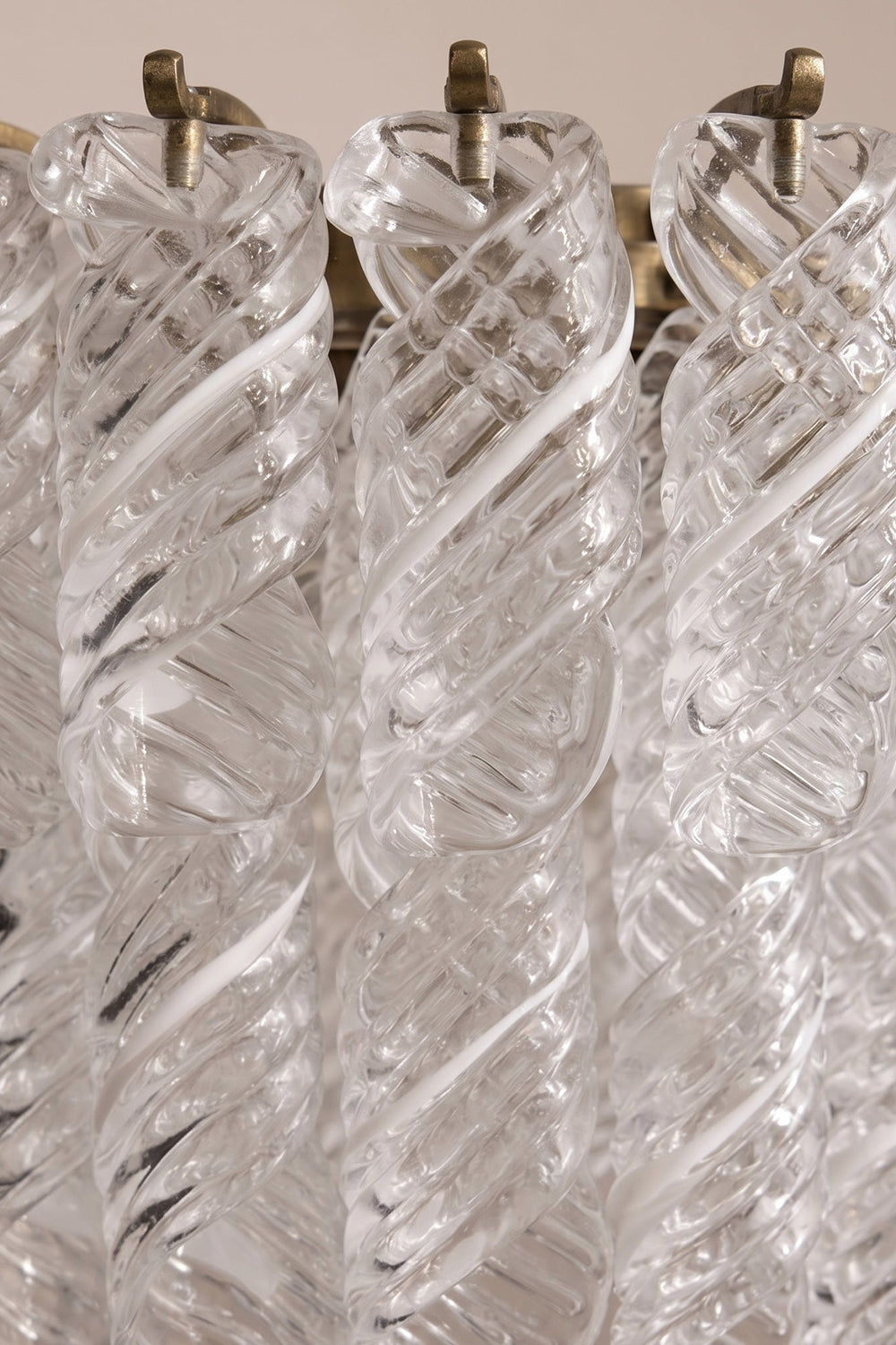 Evangeline Tiered Twisted Glass Chandelier | Unlit Glass Textures | Macro close-up shot focusing on the craftsmanship and spiral textures of the clear twisted glass reeds on metal hooks | Detail shot | Samu Lamp