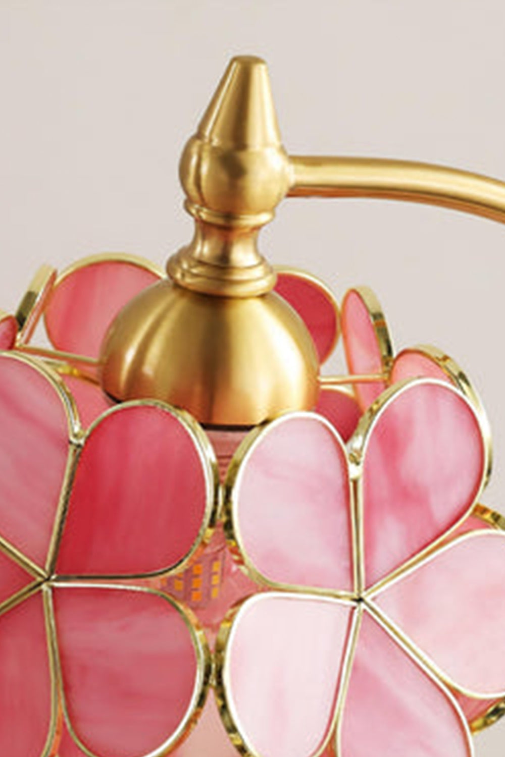 Evanthe Blossom Stained Glass Table Lamp | Stained Glass, Metal | Close-up focus on the polished gold brass top hardware cap and screw finial connecting the stem to the floral glass shade | Detail shot | Samu Lamp