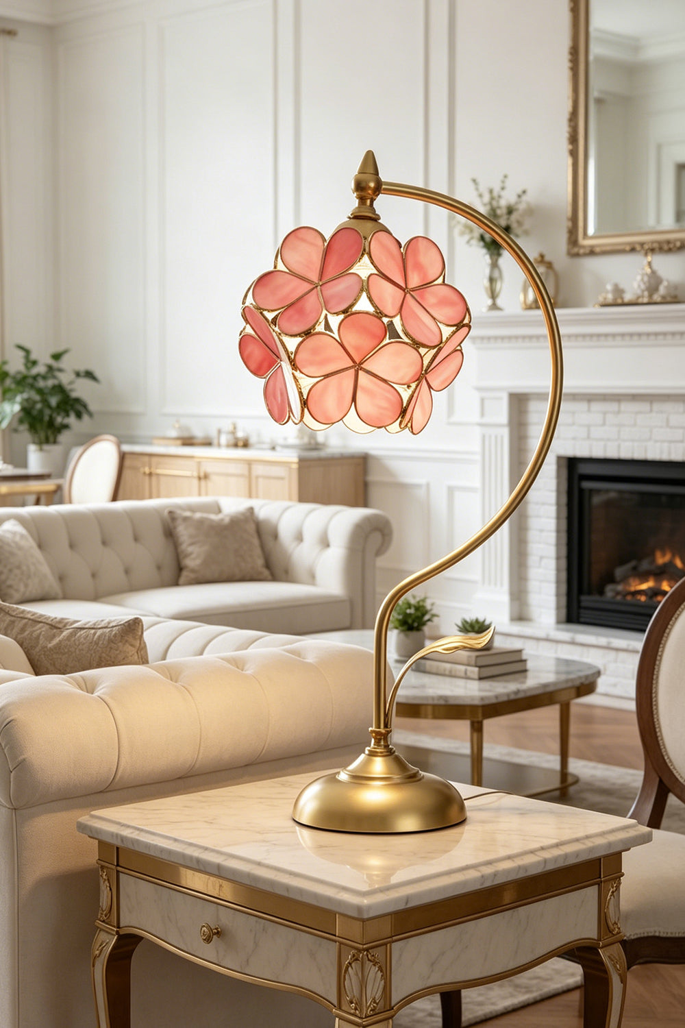 Evanthe Blossom Stained Glass Table Lamp | Stained Glass, Metal | Pink variant glowing softly on an elegant marble-topped side table next to a cream fabric sofa | Samu Lamp