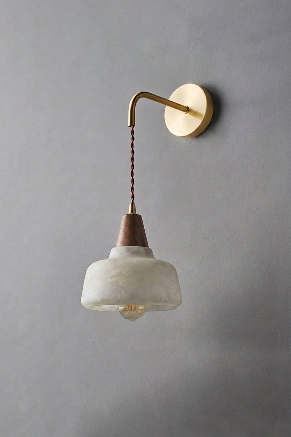 Everett Alabaster Hook-Arm Wall Sconce featuring a brass-toned arm and natural alabaster shade.