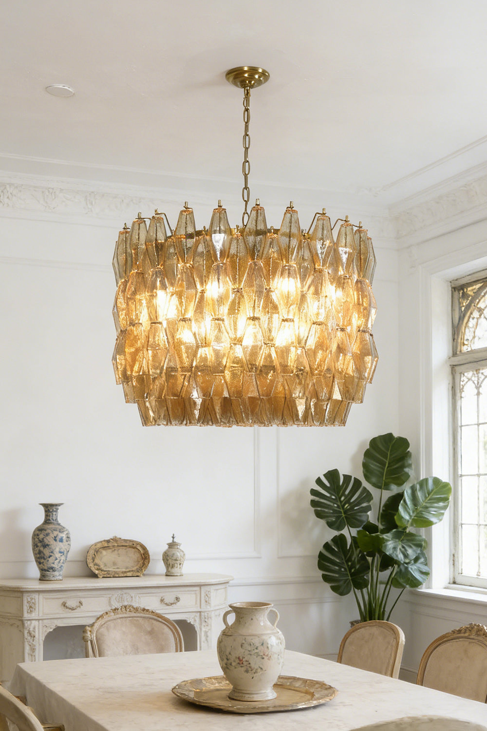 Amber drum Sorrento chandelier over dining table | Metal, Glass | Centered in a traditional dining room with wooden chairs | Samu Lamp