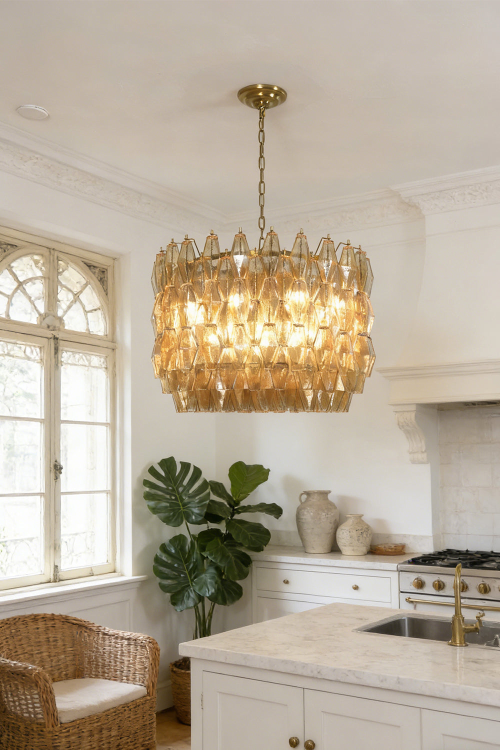 Faceted amber glass drum pendant light | Metal, Glass | Installed in a bright kitchen area with white cabinetry | Samu Lamp