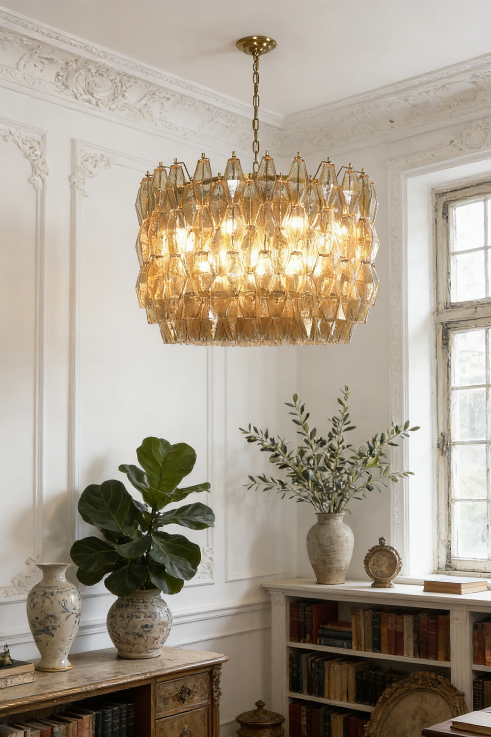 Faceted amber glass chandelier for library | Metal, Glass | Installed in a study with bookshelves and indoor plants | Samu Lamp