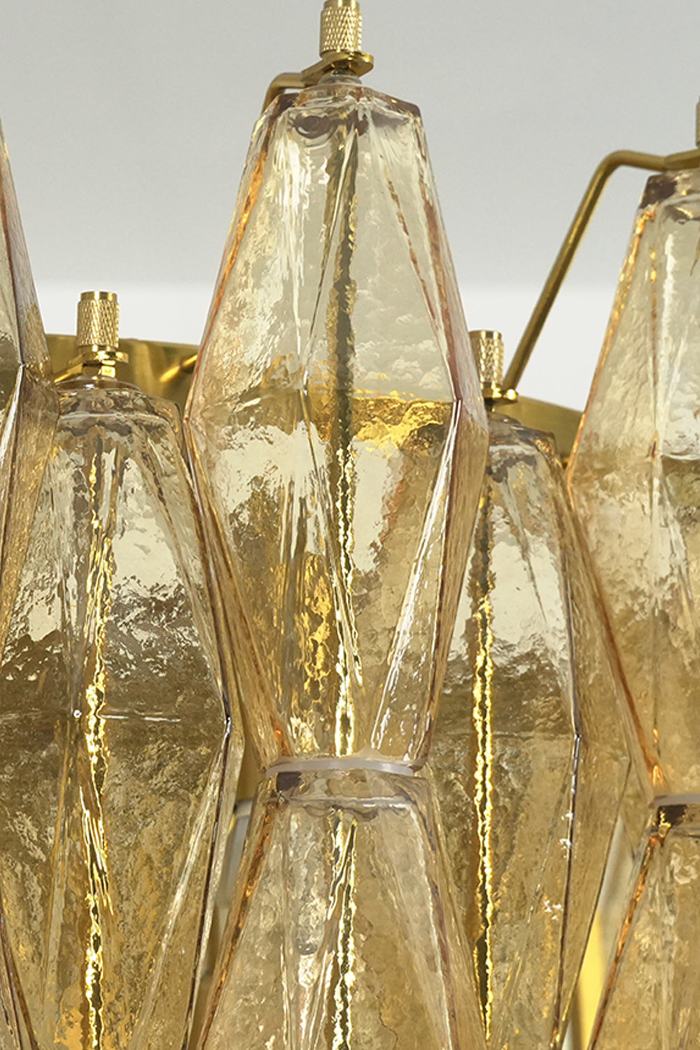 Detail shot of amber glass prism attachment | Metal, Glass | Close-up of the metal hook and textured glass | Samu Lamp