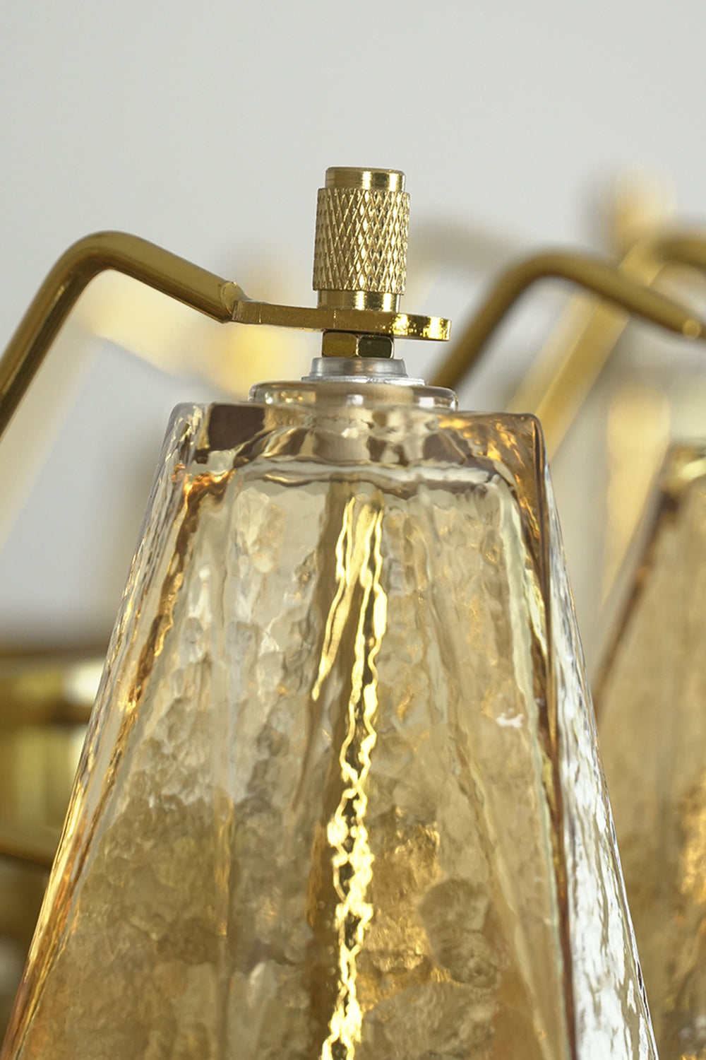 Close-up of glass prism screw connection | Metal, Glass | Macro shot of the faceted glass top and metal hardware | Samu Lamp