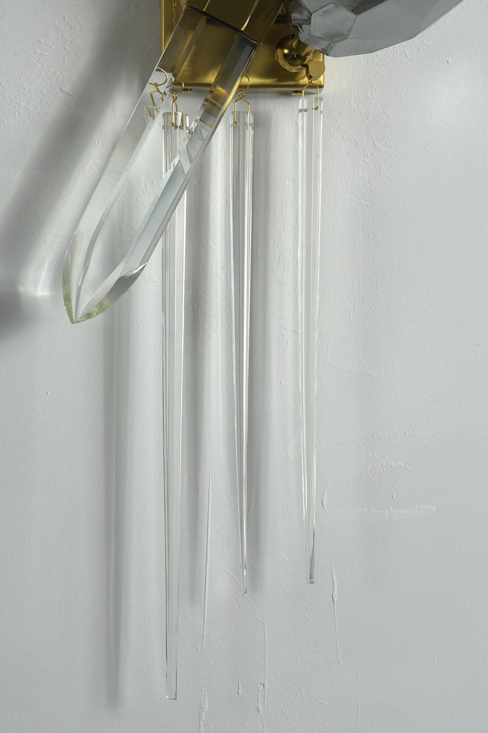 Faucenne Pierced Shade Crystal Spear Wall Lamp | Cut Crystal and Brass | Close-up view of the long hanging clear crystal rods | Samu Lamp