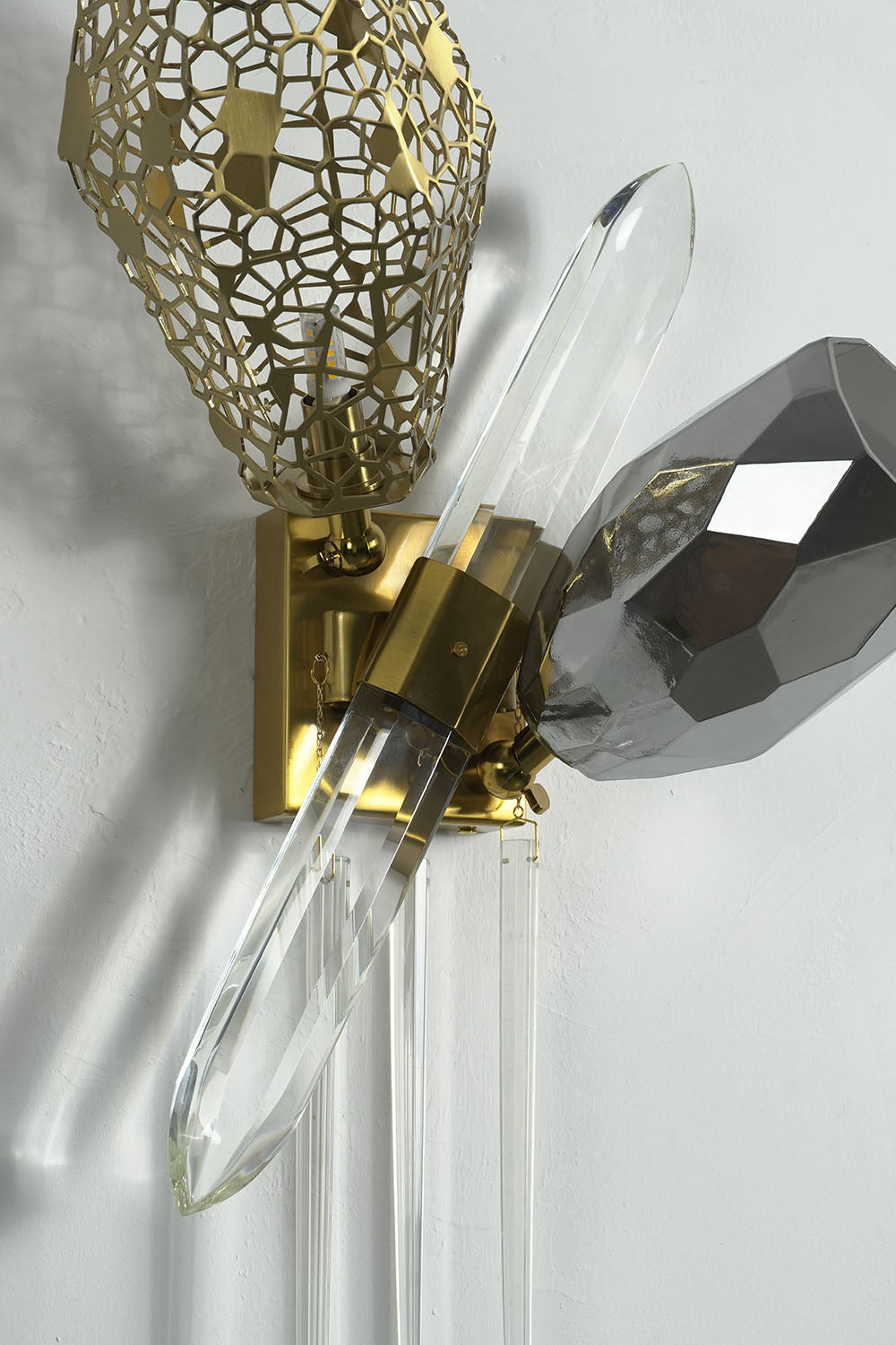 Faucenne Pierced Shade Crystal Spear Wall Lamp | Cut Crystal and Brass | Detail shot of the pierced brass shade and clear crystal spear | Samu Lamp