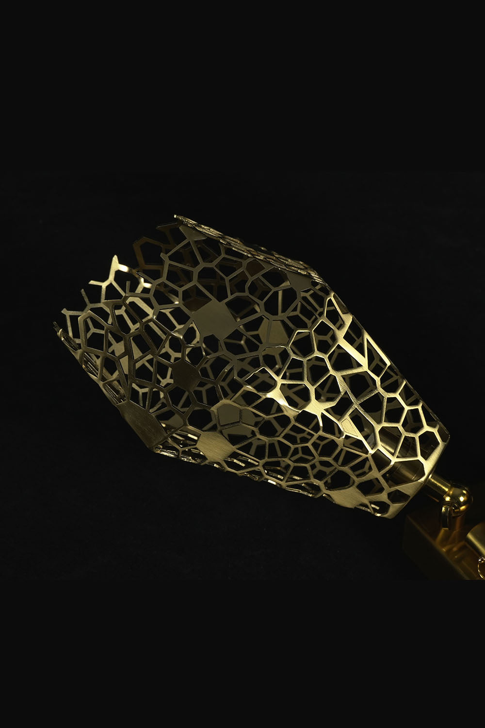 Faucenne Pierced Shade Crystal Spear Wall Lamp | Cut Crystal and Brass | Detail shot highlighting the golden pierced brass shade on dark background | Samu Lamp