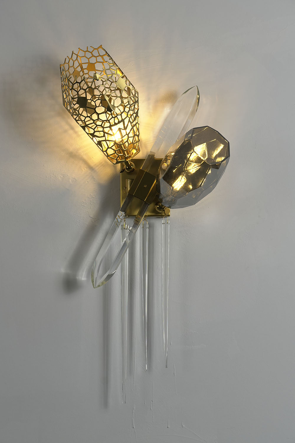 Faucenne Pierced Shade Crystal Spear Wall Lamp | Cut Crystal and Brass | Illuminated wall sconce view casting soft ambient light pattern | Samu Lamp