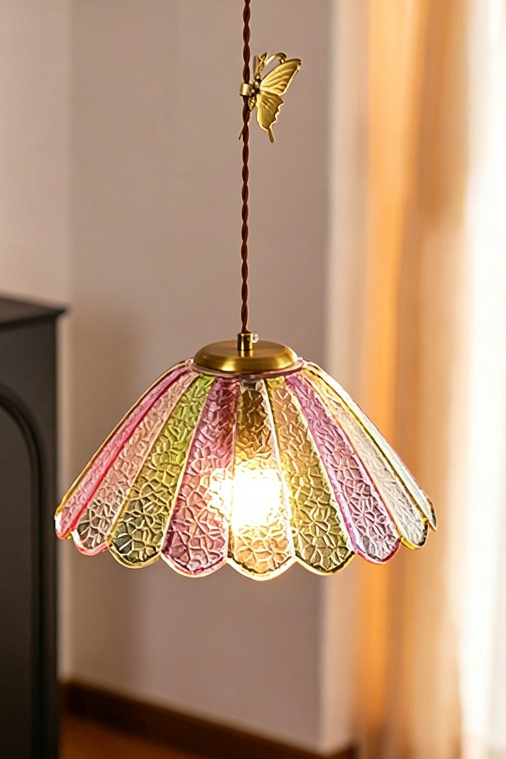 Faye Pastel Scalloped Glass Pendant Lamp | Glass, Metal | Close-up shot of the single illuminated pastel glass pendant throwing a warm golden light in a cozy corner | Samu Lamp