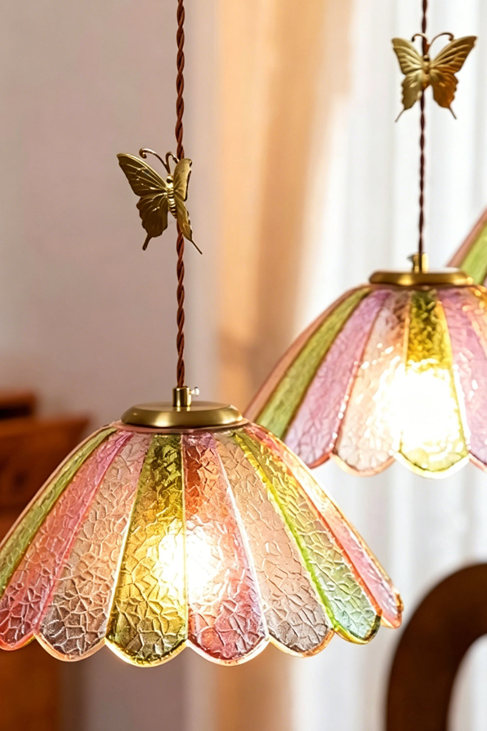 Faye Pastel Scalloped Glass Pendant Lamp | Glass, Metal | Two butterfly glass pendant lights hanging at staggered heights next to soft window curtains | Samu Lamp