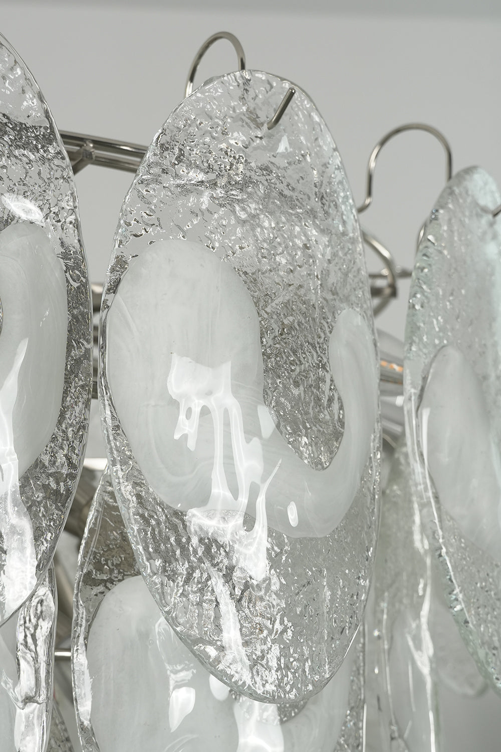 Detailed view of unlit textured glass leaves | Glass | Close-up showing the organic pattern of the Frostelle art chandelier | Samu Lamp
