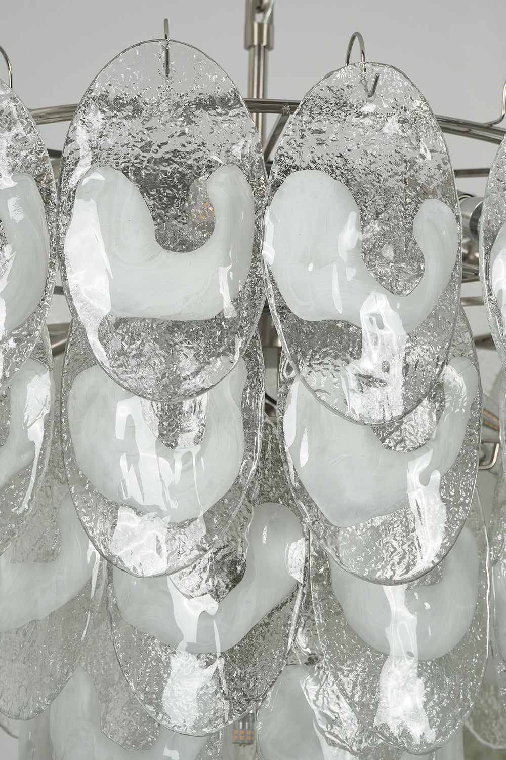 Detailed close-up of unlit cascading glass leaves | Glass | Showing the layering and transparency of Frostelle chandelier | Samu Lamp