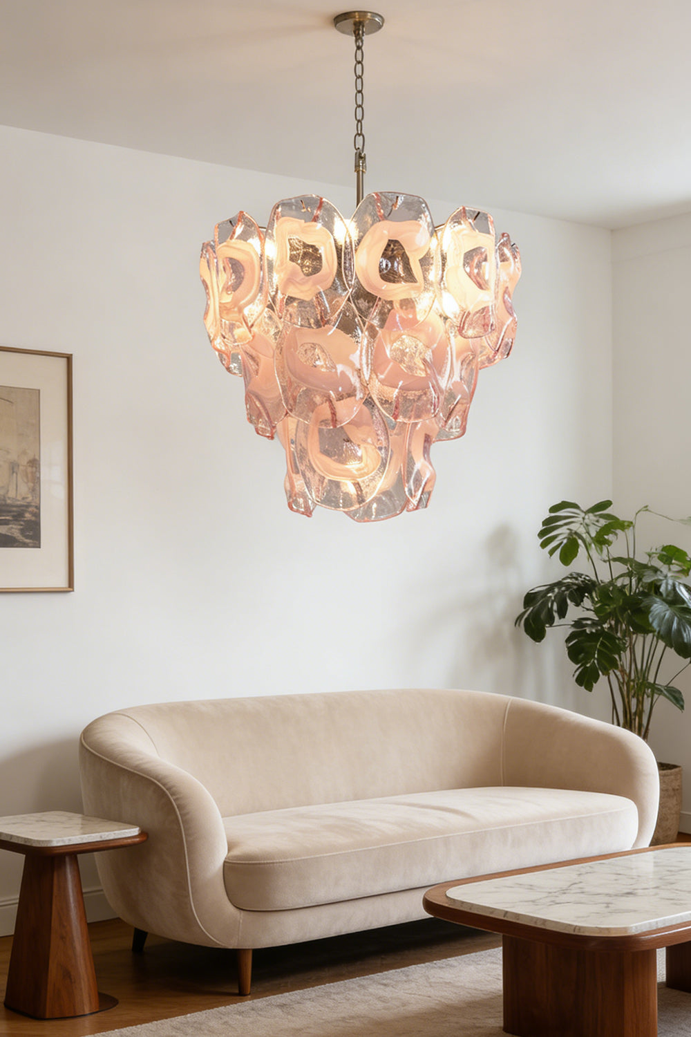 Tiered pink petal chandelier | Metal, Glass | Over a curved sofa in a contemporary living room | Samu Lamp