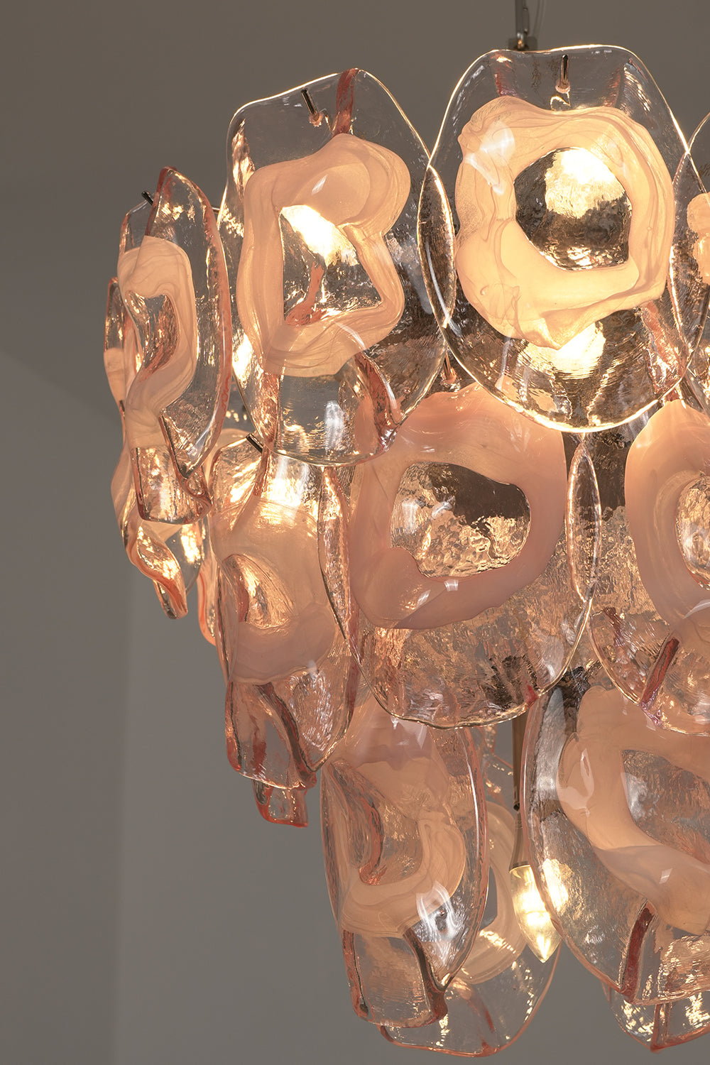 Lit pink glass petals detail | Glass | Close-up showing warm illumination through pink glass | Samu Lamp