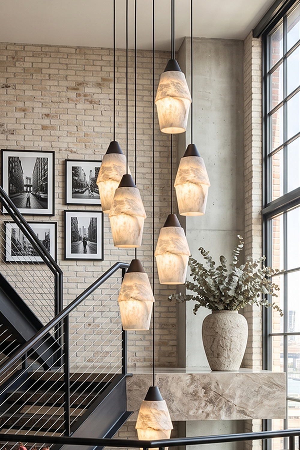 Gemma Staggered Alabaster Cluster Chandelier | Cozy Mood Lighting | Interior scene highlighting the fully illuminated cluster lamp hanging next to a brick accent wall with artwork | Samu Lamp