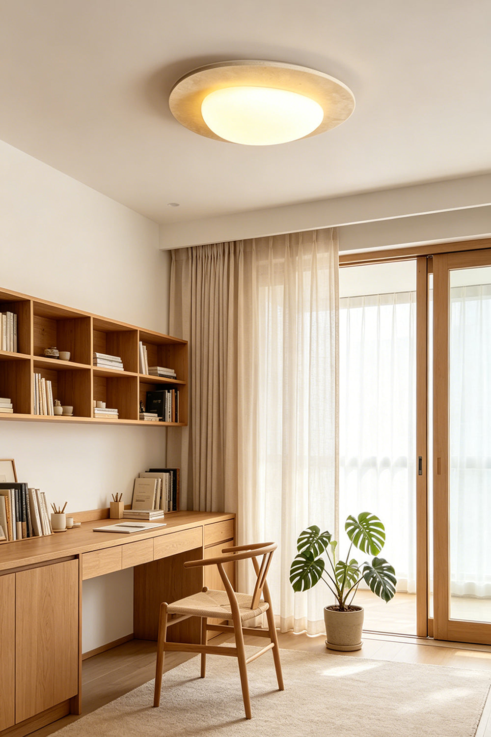 Geoidal Halo Travertine Ceiling Light | Travertine, Glass | Illuminated in a modern home office with wood desk and plants | Samu Lamp