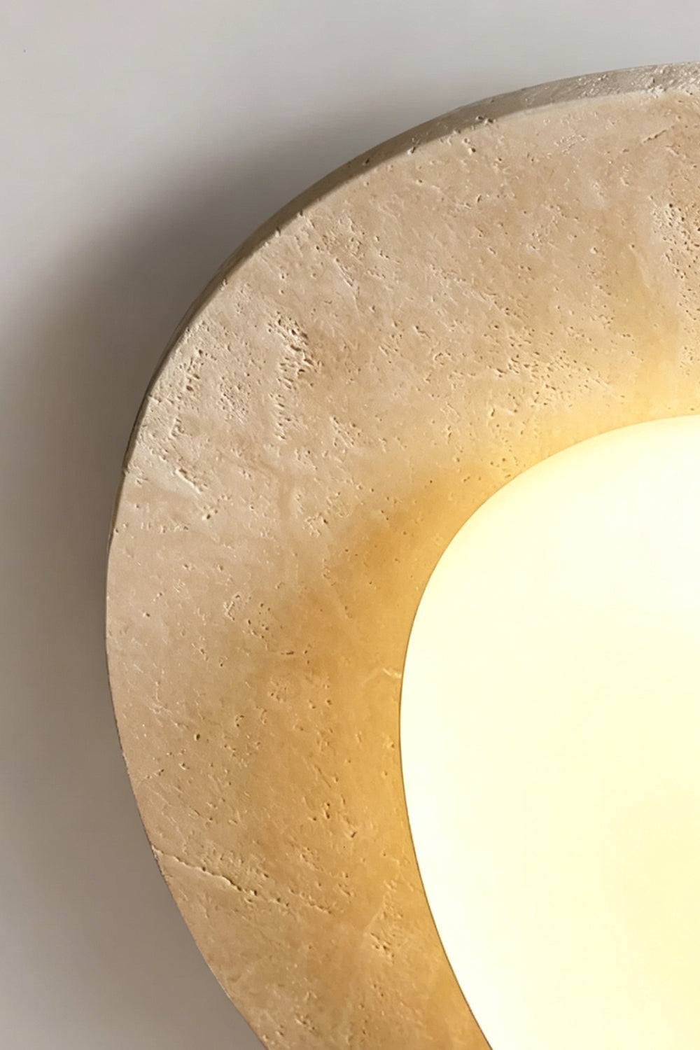 Travertine Ceiling Light Detail | Travertine, Glass | Close-up of lit stone halo edge | Porous texture and warm glow | Samu Lamp