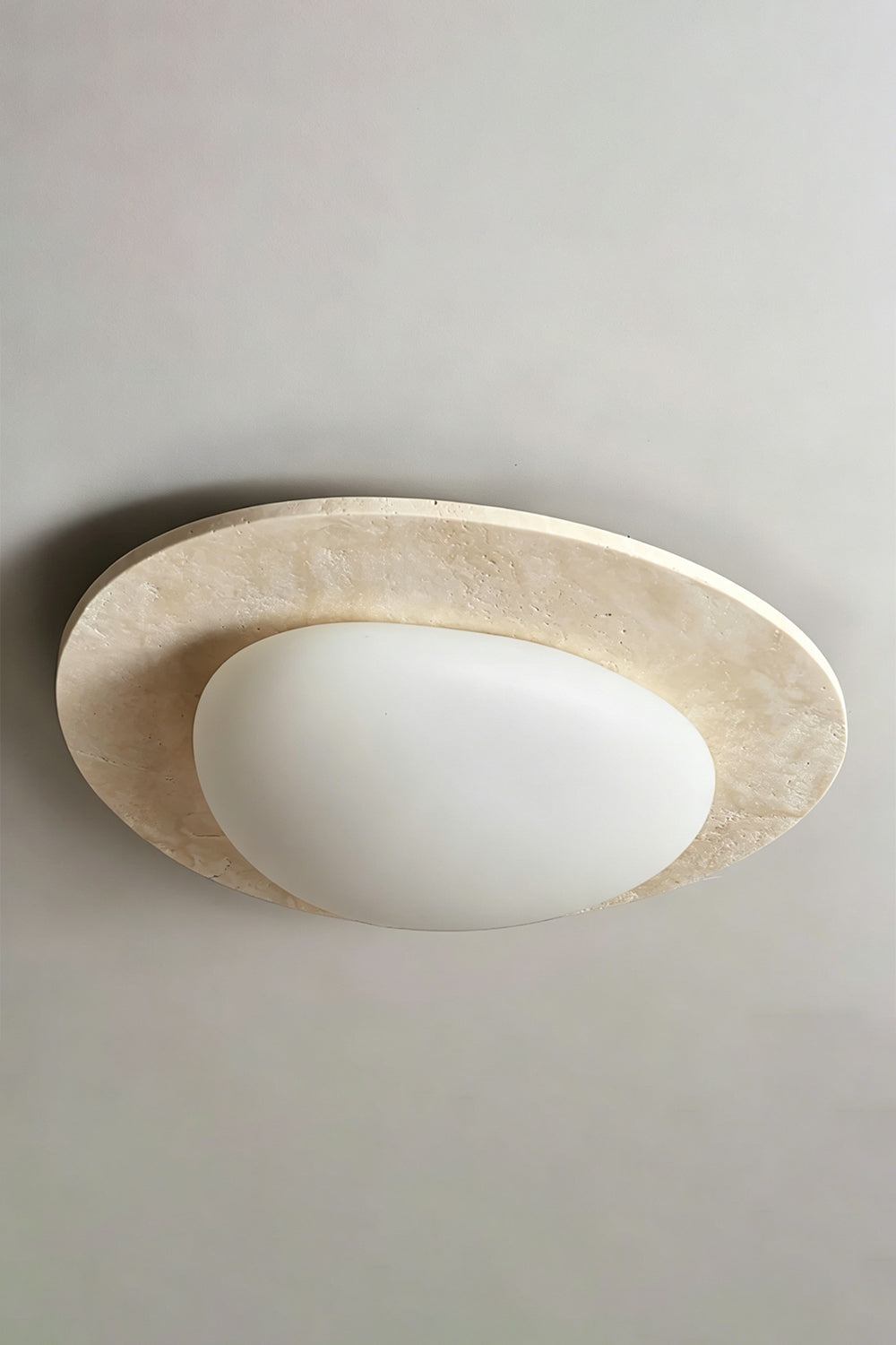 Travertine Ceiling Light Detail | Travertine, Glass | Center oval diffuser view against grey ceiling | Smooth glass focus | Samu Lamp