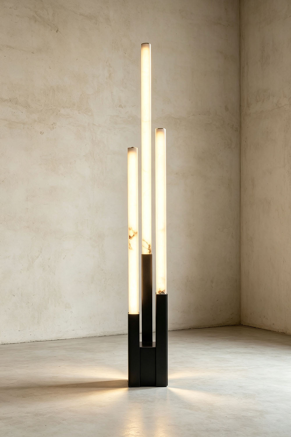 Gethin Triple Column Alabaster Floor Lamp | Natural Alabaster and Metal | Studio shot of illuminated floor lamp on a neutral backdrop | Samu Lamp