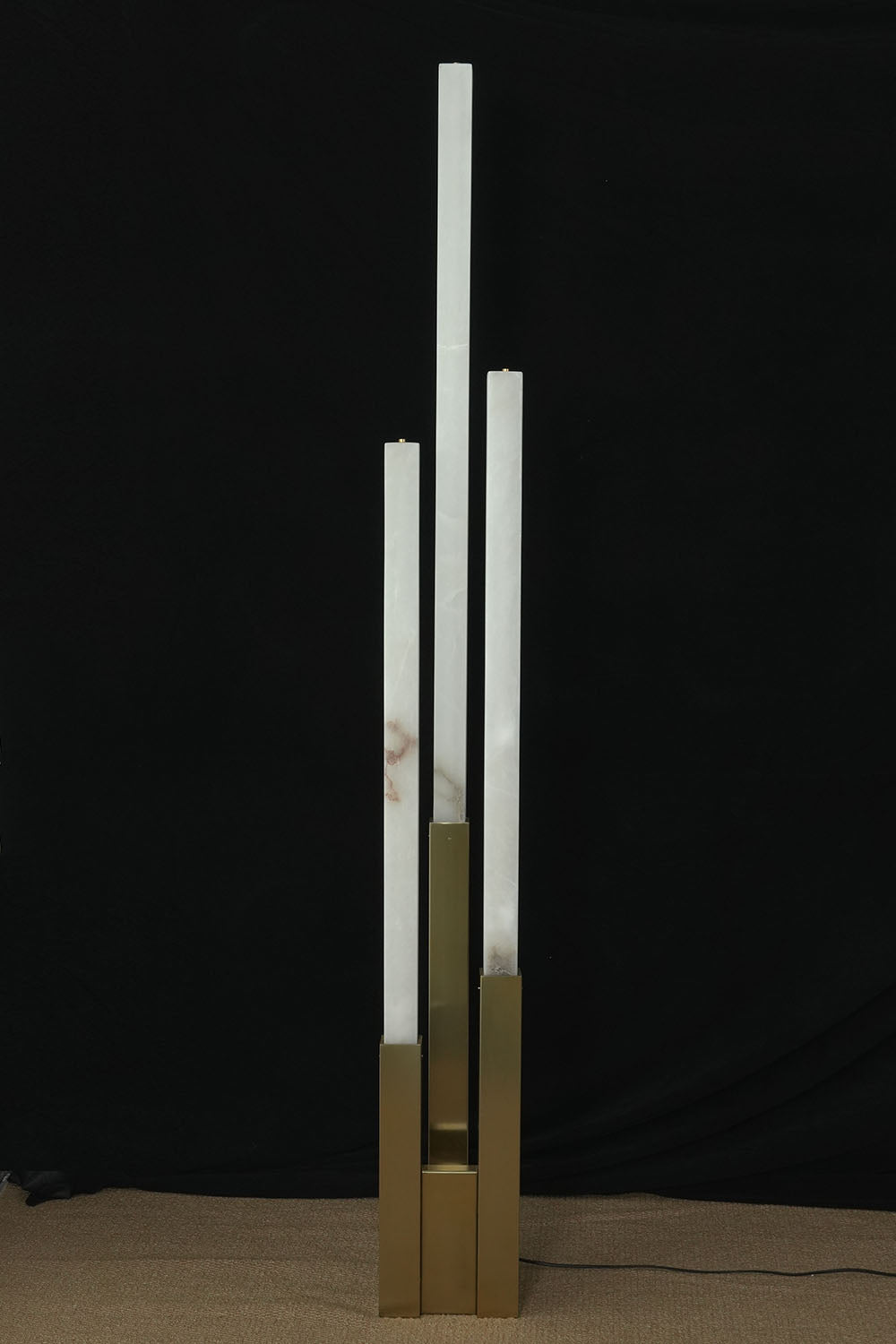 Gethin Triple Column Alabaster Floor Lamp | Natural Alabaster and Brass | Full unlit product view displayed against a dark studio backdrop | Samu Lamp