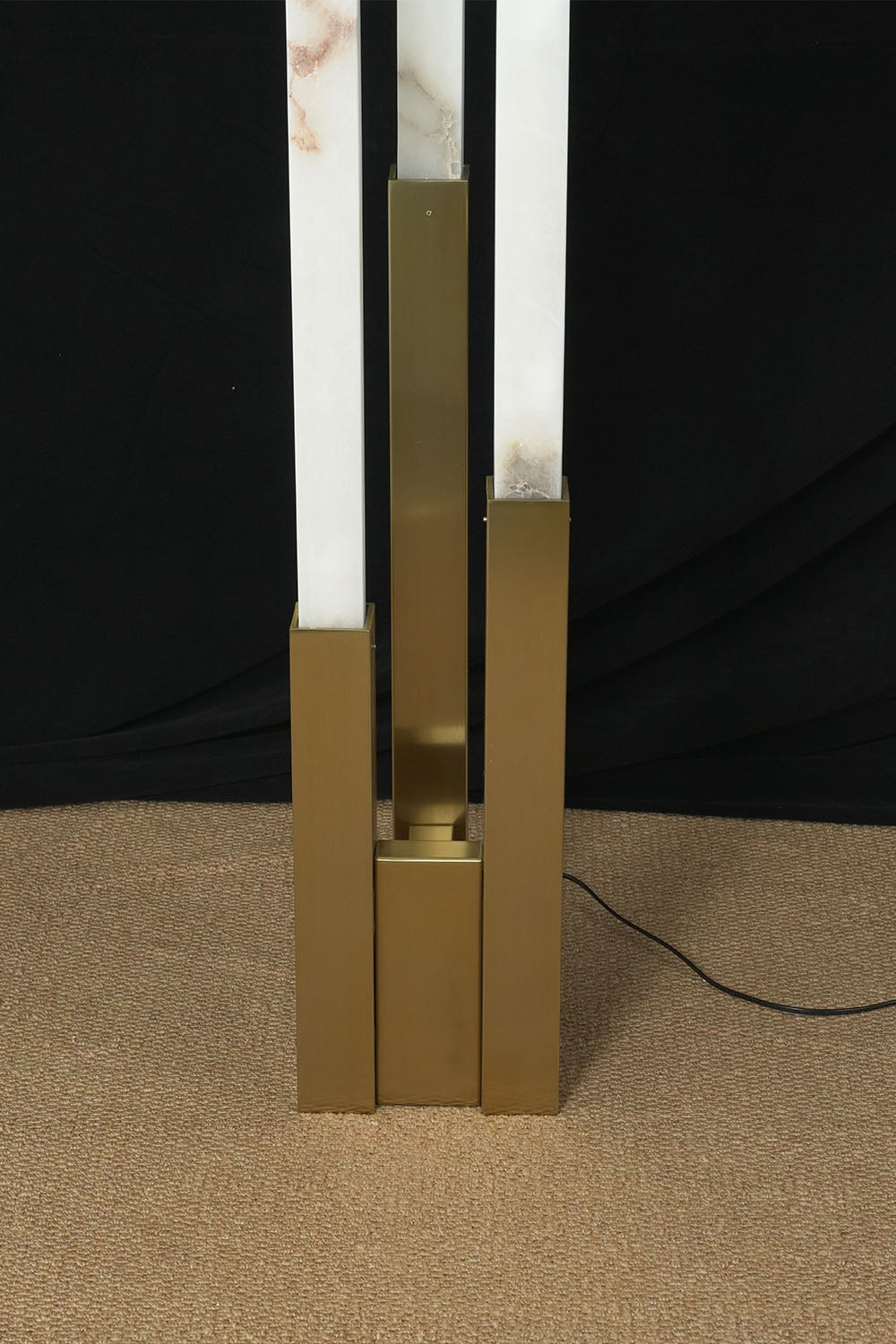 Gethin Triple Column Alabaster Floor Lamp | Natural Alabaster and Brass | Detail shot of the brass base holding the three alabaster columns | Samu Lamp