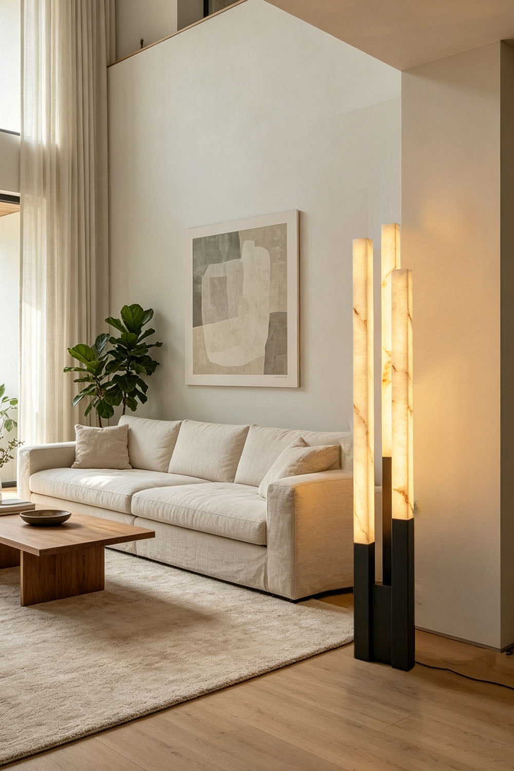Gethin Triple Column Alabaster Floor Lamp | Natural Alabaster and Brass | Lighting up a high-ceiling living room with beige sofa | Samu Lamp