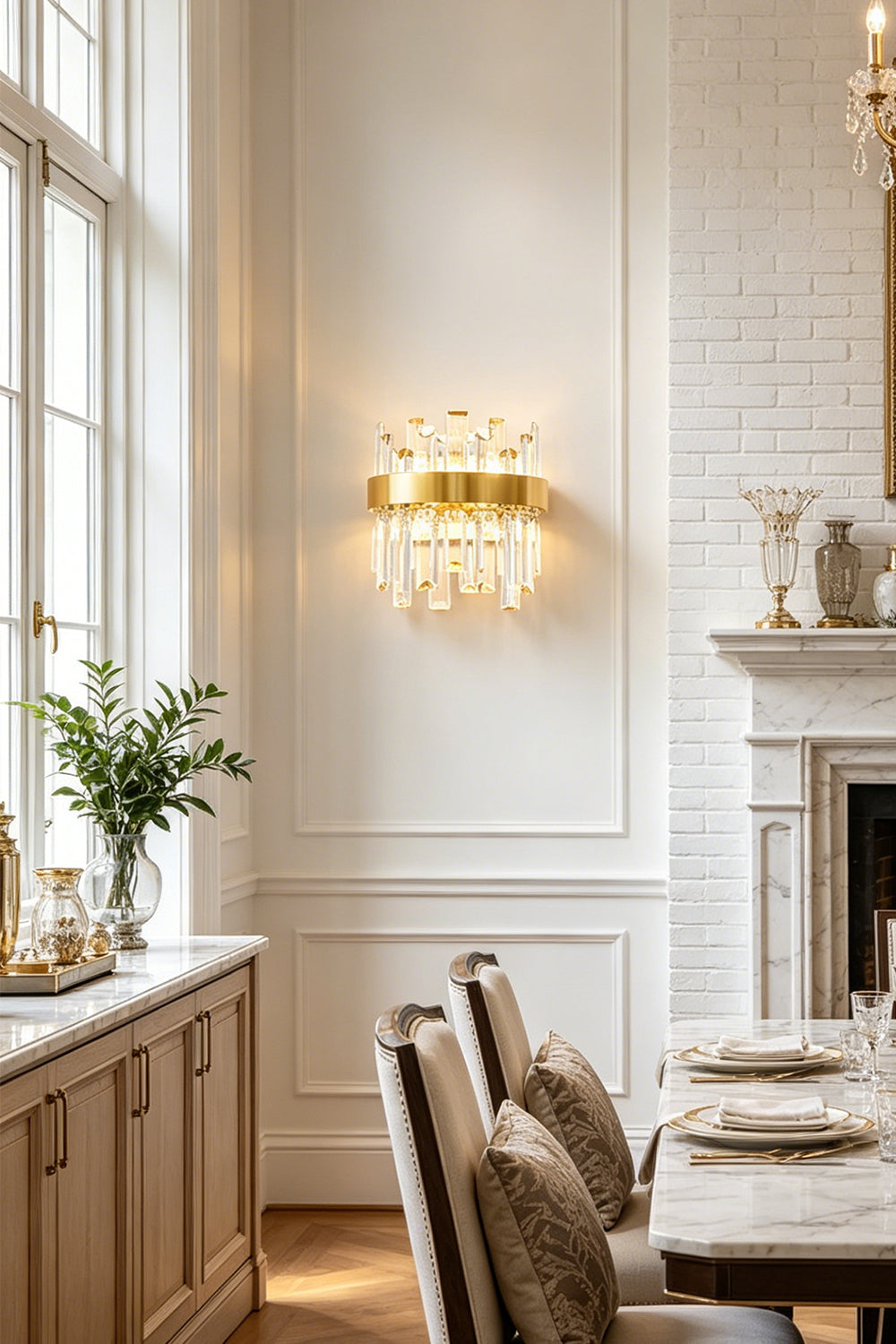 Glacia Tiered Crystal Statement Wall Lamp | Crystal, Metal | Providing sophisticated wall accent lighting in a classical dining space next to a long dining table and white paneled walls | Samu Lamp