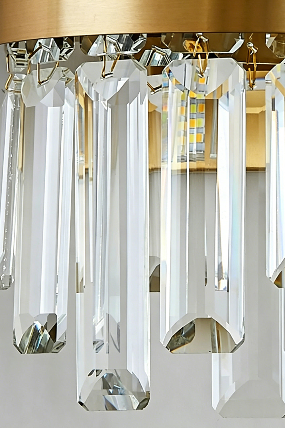Glacia Tiered Crystal Statement Wall Lamp | Crystal, Metal | Close-up focus highlighting the hollow rounded bottom edge and sparkling facet reflections of the clear tiered crystal glass rods | Detail shot | Samu Lamp