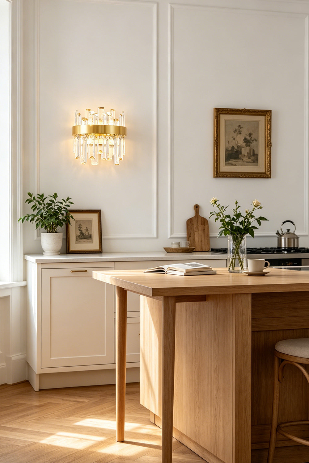 Glacia Tiered Crystal Statement Wall Lamp | Crystal, Metal | Styled beautifully on a white wall above a wooden dining table or console counter in a sunlit open-concept kitchen area | Samu Lamp